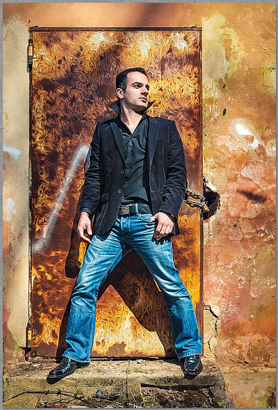 breitbeiniger stand vor einer rostigen tür mit jacke und jeans dirk schmitz